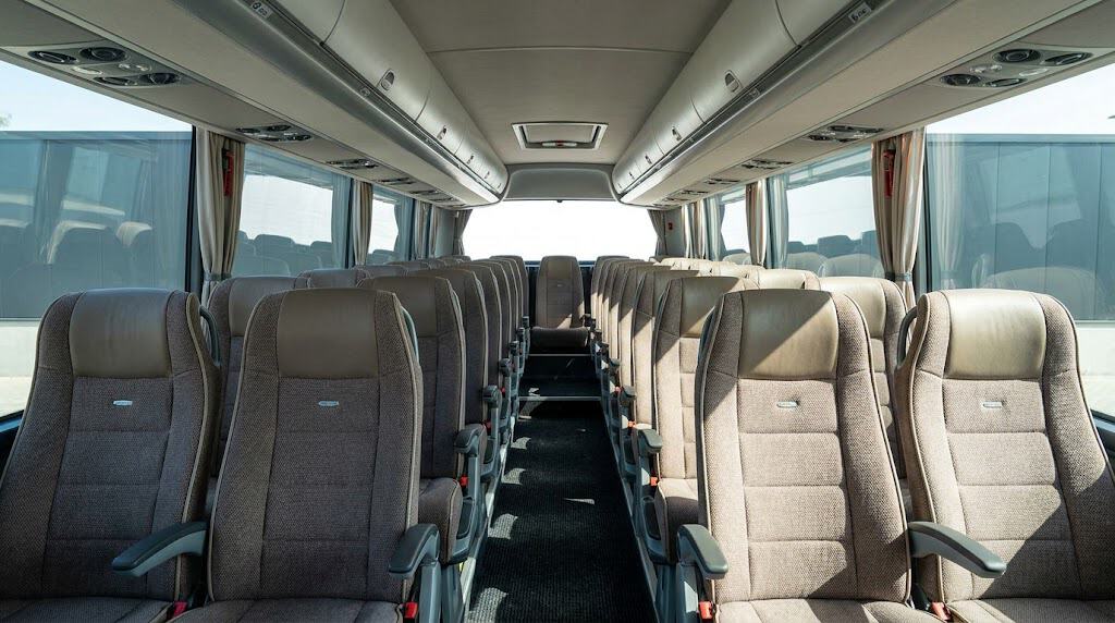 How Many People Fit in a Bus Charter Singapore? Complete Capacity Guide 1 clean 45 seater coach interior with rows of seats, overhead luggage racks and air con vents